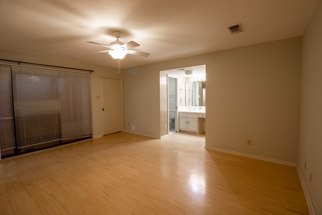1127 Lois Street Kerrville, TX 78028 - Photo 12 of 23 wooden floor in an empty room with a window