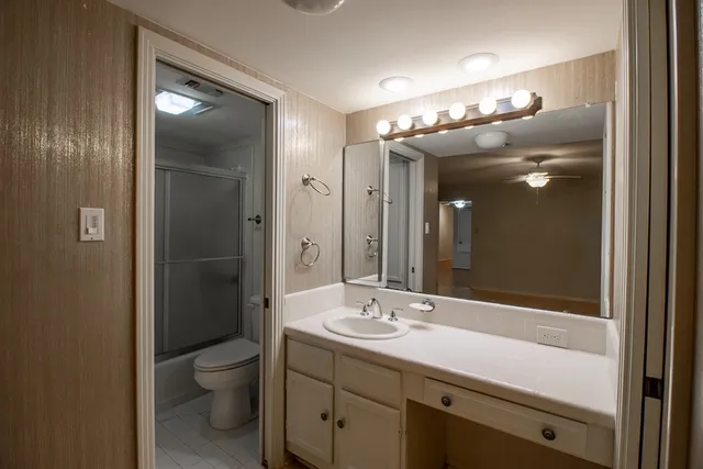 a bathroom with a shower and a toilet