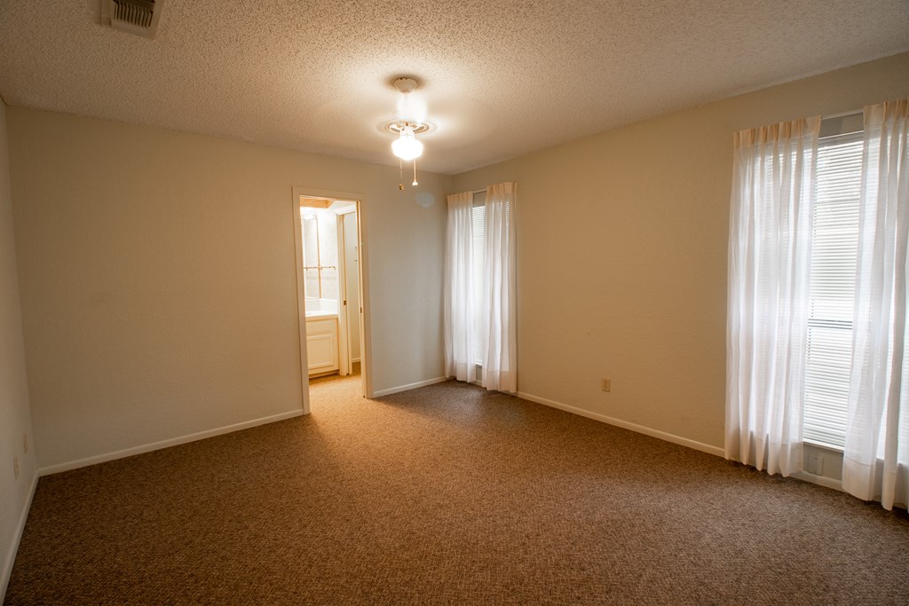 1127 Lois Street Kerrville, TX 78028 - Photo 17 of 23 an empty room with chandelier fan and windows