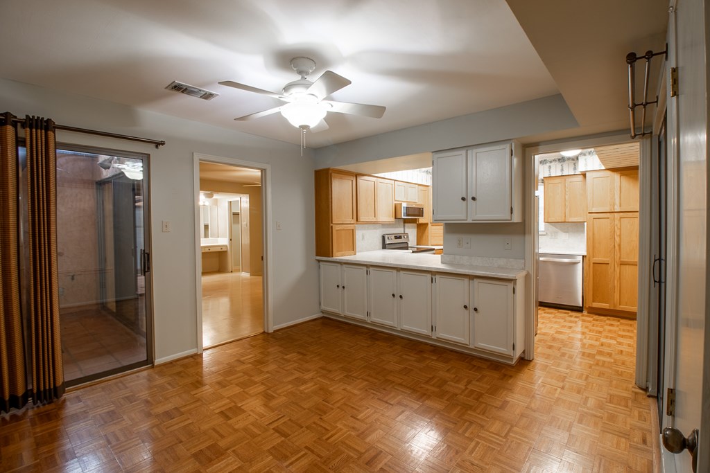 1127 Lois Street Kerrville, TX 78028 - Photo 9 of 23 a kitchen with stainless steel appliances granite countertop a refrigerator and a sink