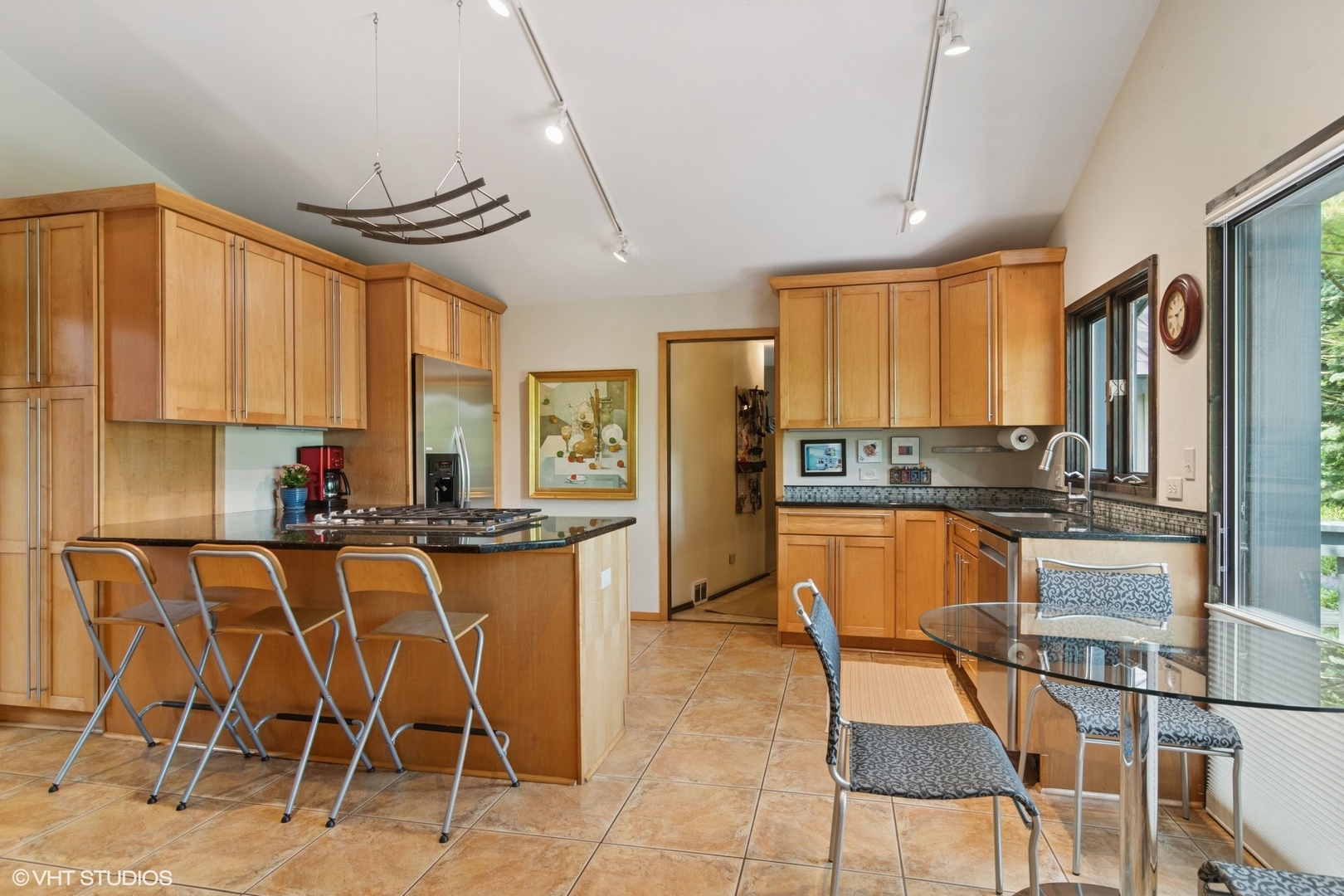 284 Oxford Road North Barrington, IL 60010 - Photo 9 of 48 a kitchen with stainless steel appliances a table and chairs in it