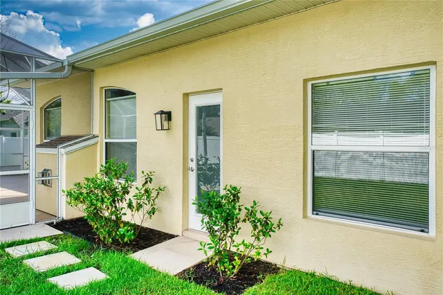 an empty room with windows and fireplace
