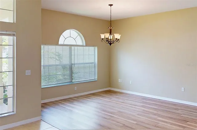 a view of a room with wooden floor and window
