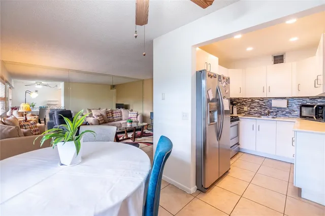 a view of kitchen with furniture and refrigerator