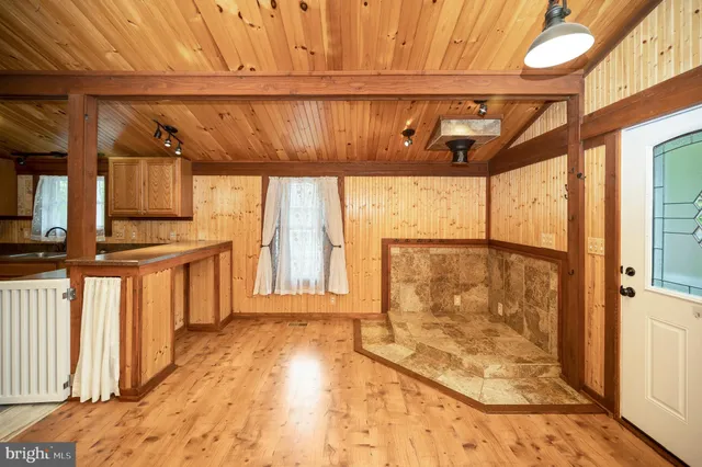 a kitchen with stainless steel appliances granite countertop a sink a stove and a refrigerator