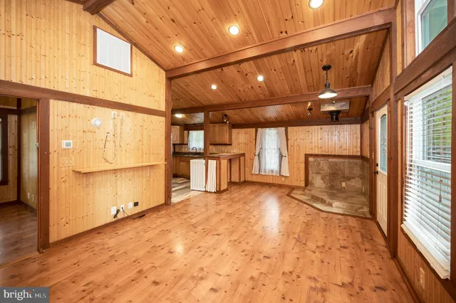 a kitchen with stainless steel appliances granite countertop a sink a counter space cabinets and a window