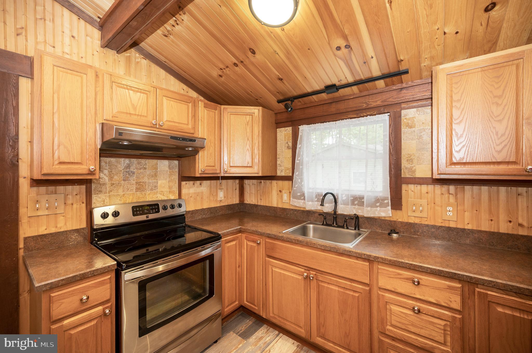 4239 Lakeview Parkway Locust Grove, VA 22508 - Photo 21 of 65 a kitchen with granite countertop a sink a stove and cabinets
