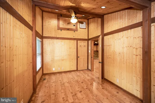 a view of a small house with roof deck front of house