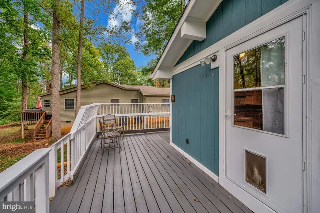 a view of balcony with wooden floor and fence