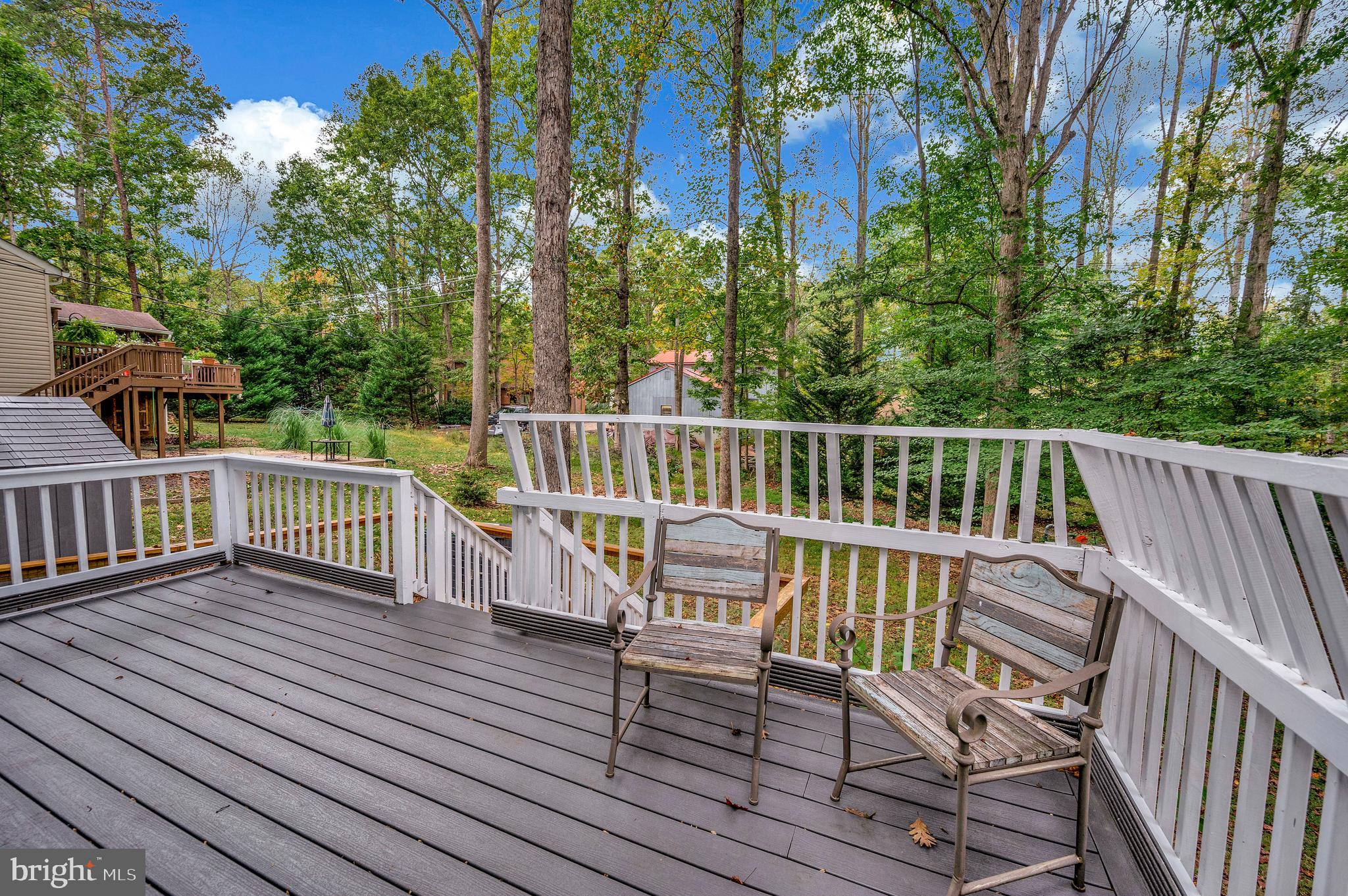 4239 Lakeview Parkway Locust Grove, VA 22508 - Photo 43 of 65 a view of a deck with two chair and wooden floor