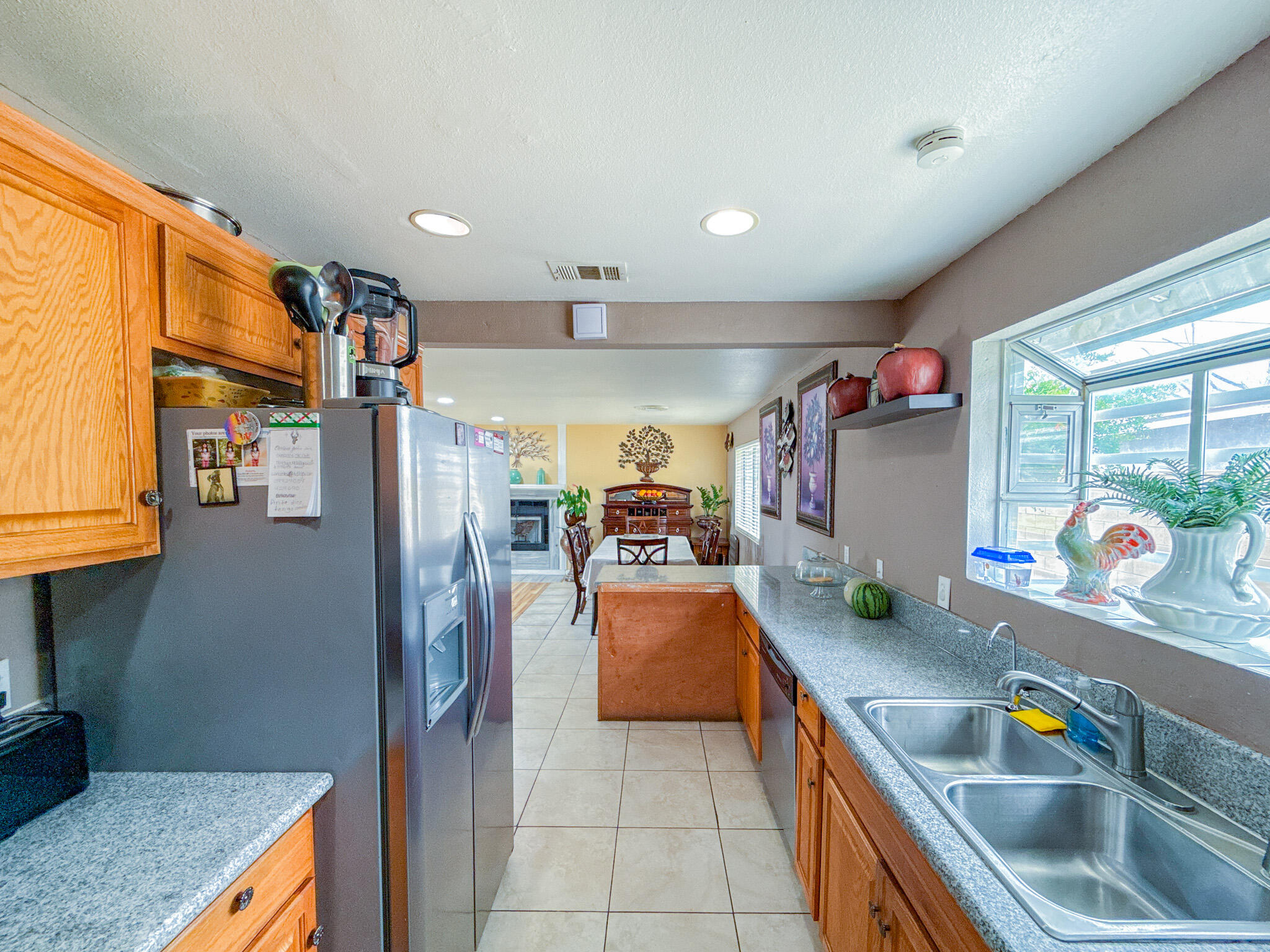 45431 Sancroft Avenue Lancaster, CA 93535 - Photo 11 of 49 a kitchen with stainless steel appliances granite countertop a sink a stove and a refrigerator
