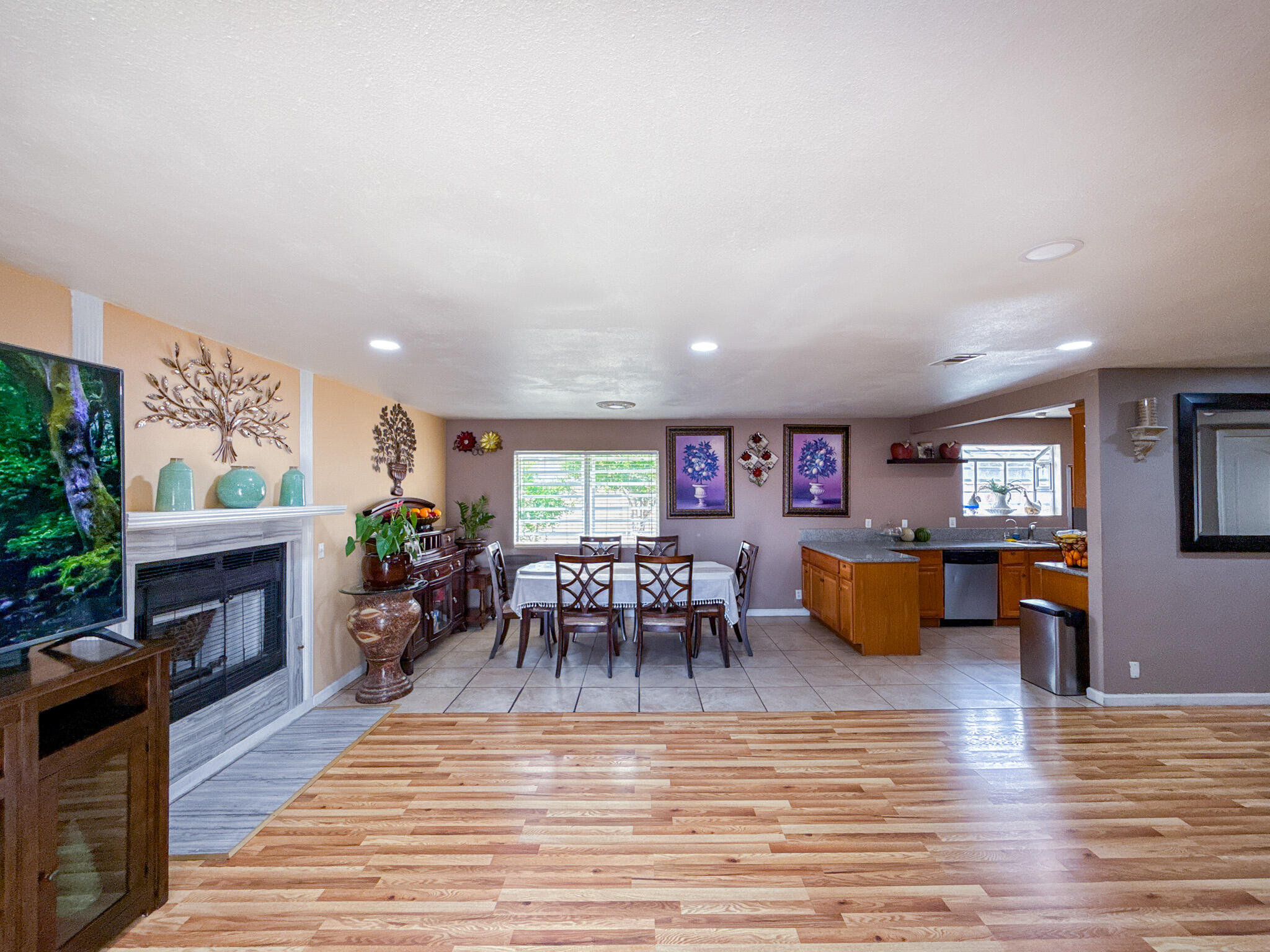 45431 Sancroft Avenue Lancaster, CA 93535 - Photo 22 of 49 a living room with furniture a fireplace a rug and a window
