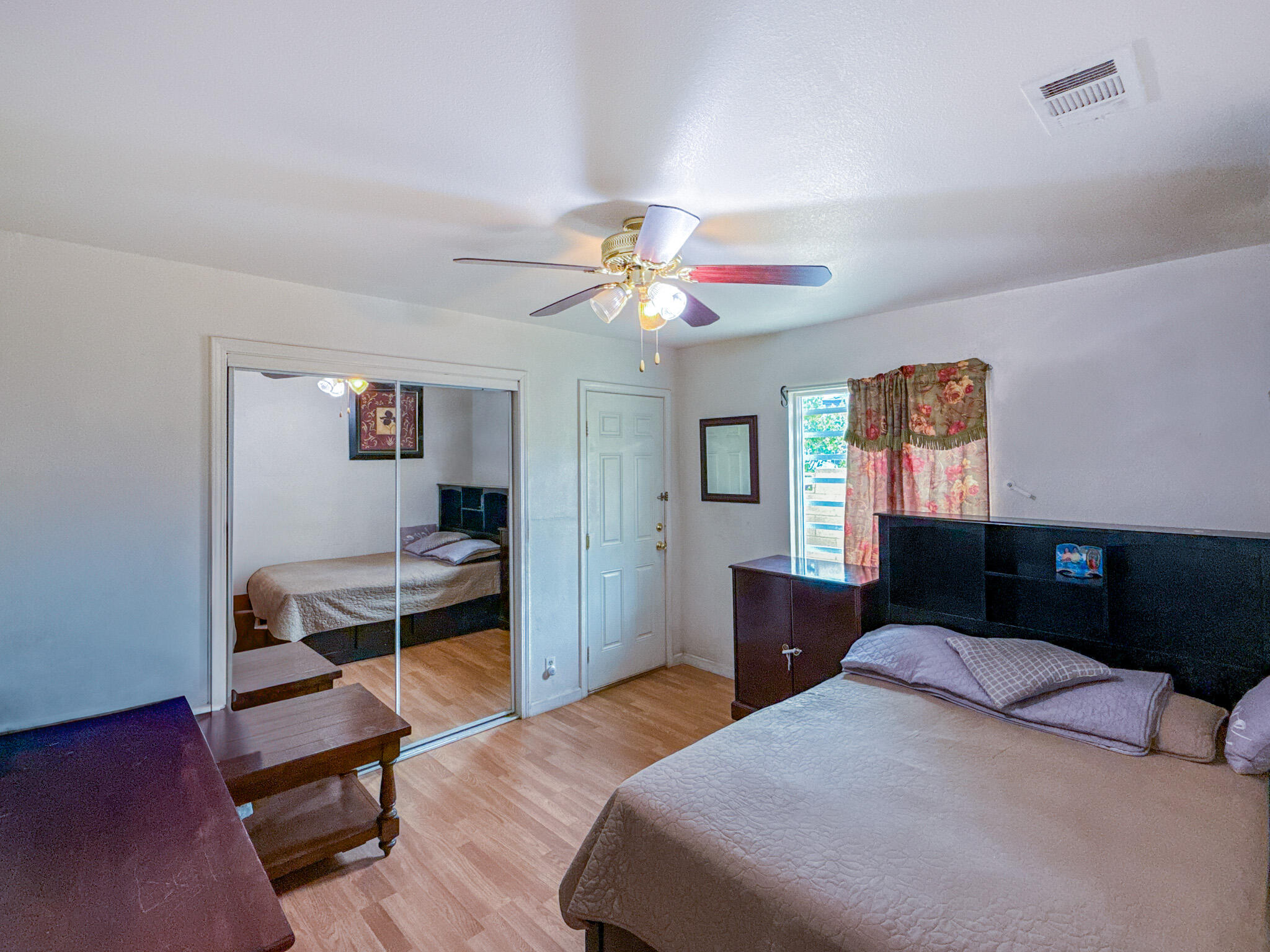 45431 Sancroft Avenue Lancaster, CA 93535 - Photo 27 of 49 a bedroom with a bed and a chandelier