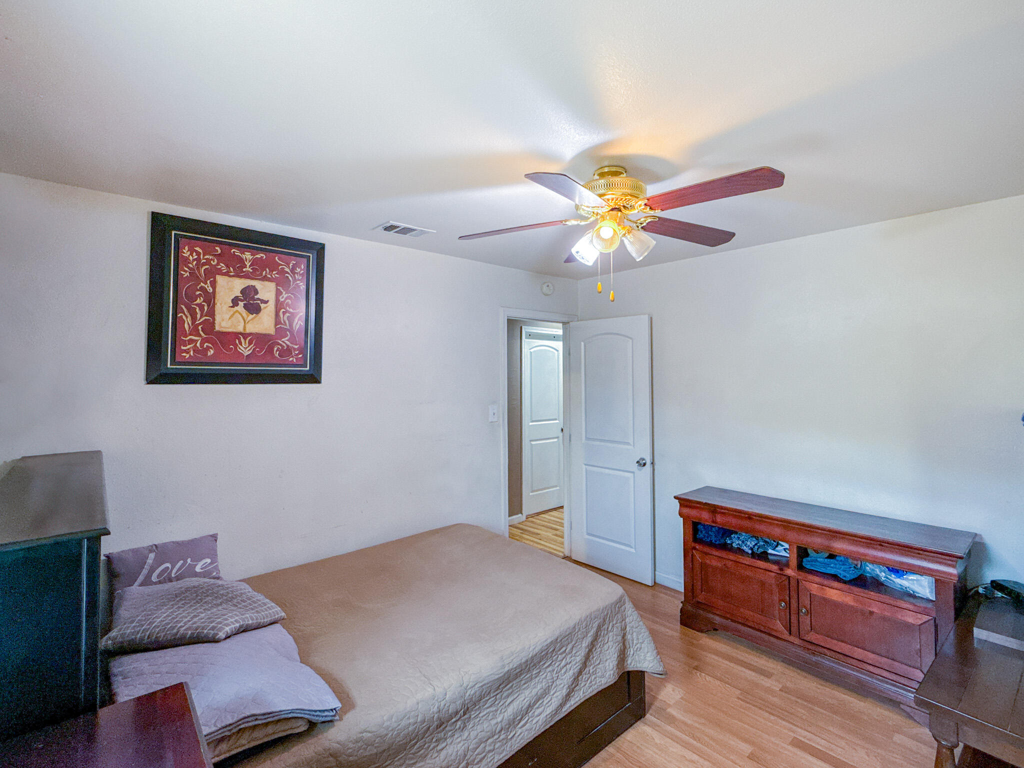 45431 Sancroft Avenue Lancaster, CA 93535 - Photo 28 of 49 a bedroom with a bed and a chandelier