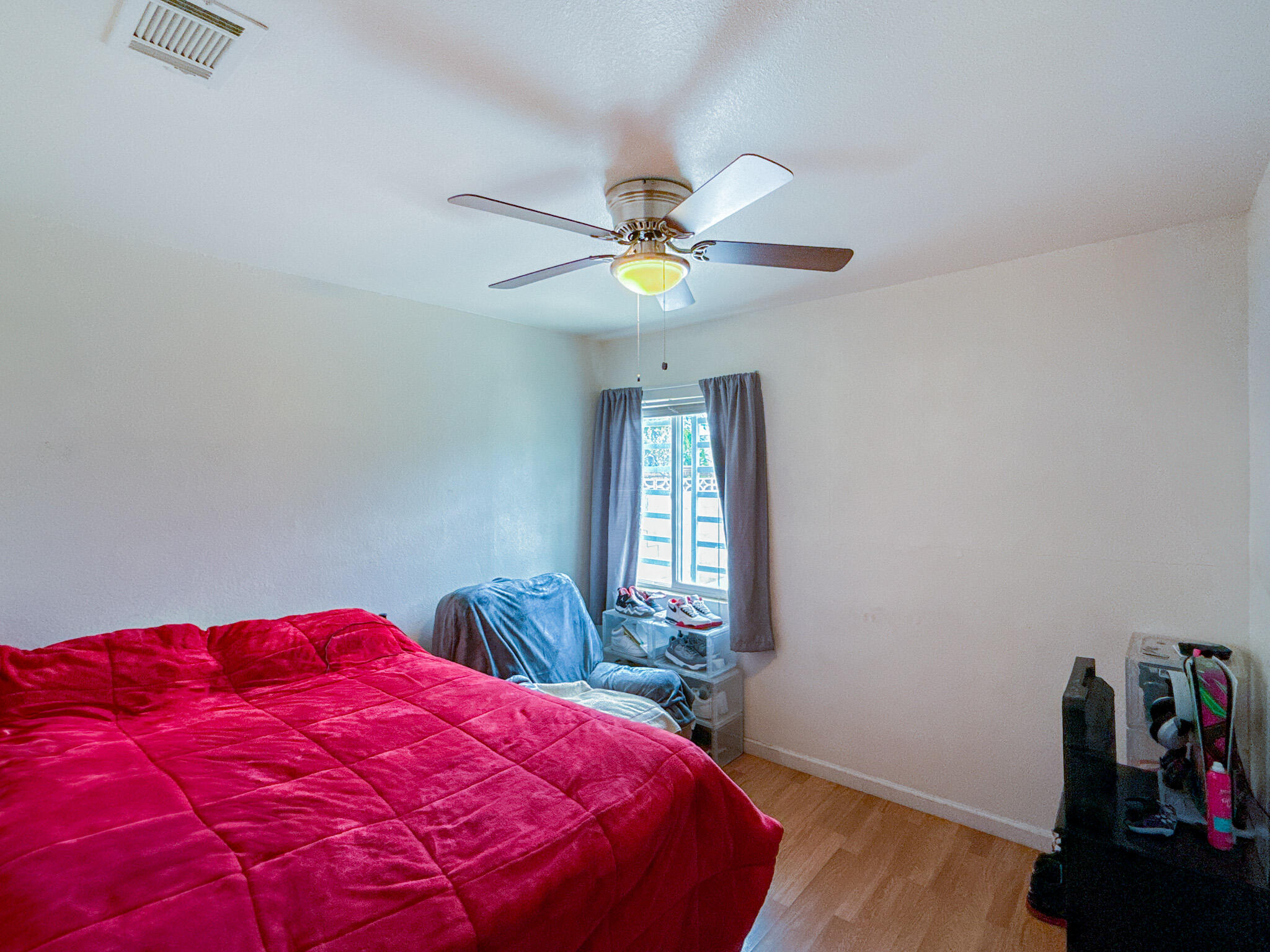 45431 Sancroft Avenue Lancaster, CA 93535 - Photo 29 of 49 a bedroom with a bed and a chandelier