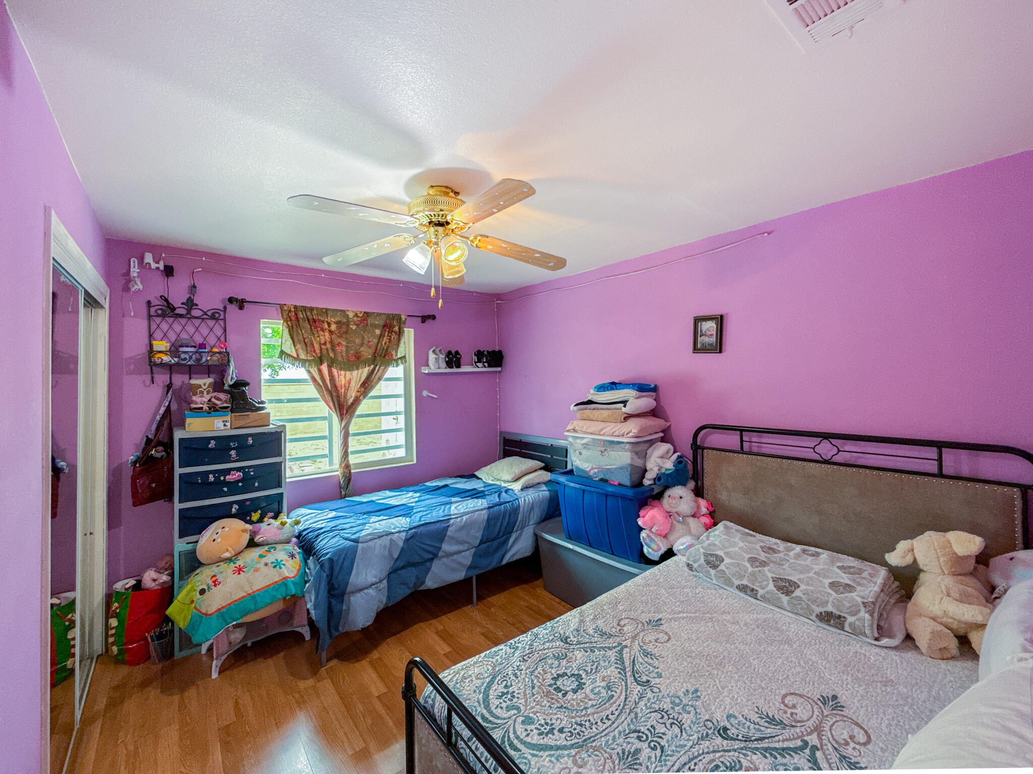 45431 Sancroft Avenue Lancaster, CA 93535 - Photo 30 of 49 a bedroom with two beds and a chandelier