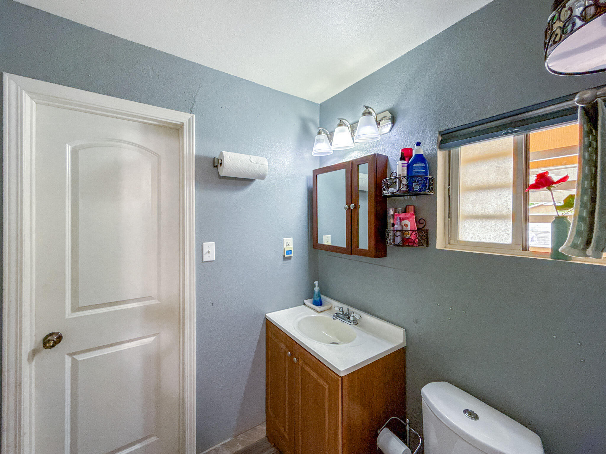 45431 Sancroft Avenue Lancaster, CA 93535 - Photo 31 of 49 a bathroom with a toilet sink and mirror
