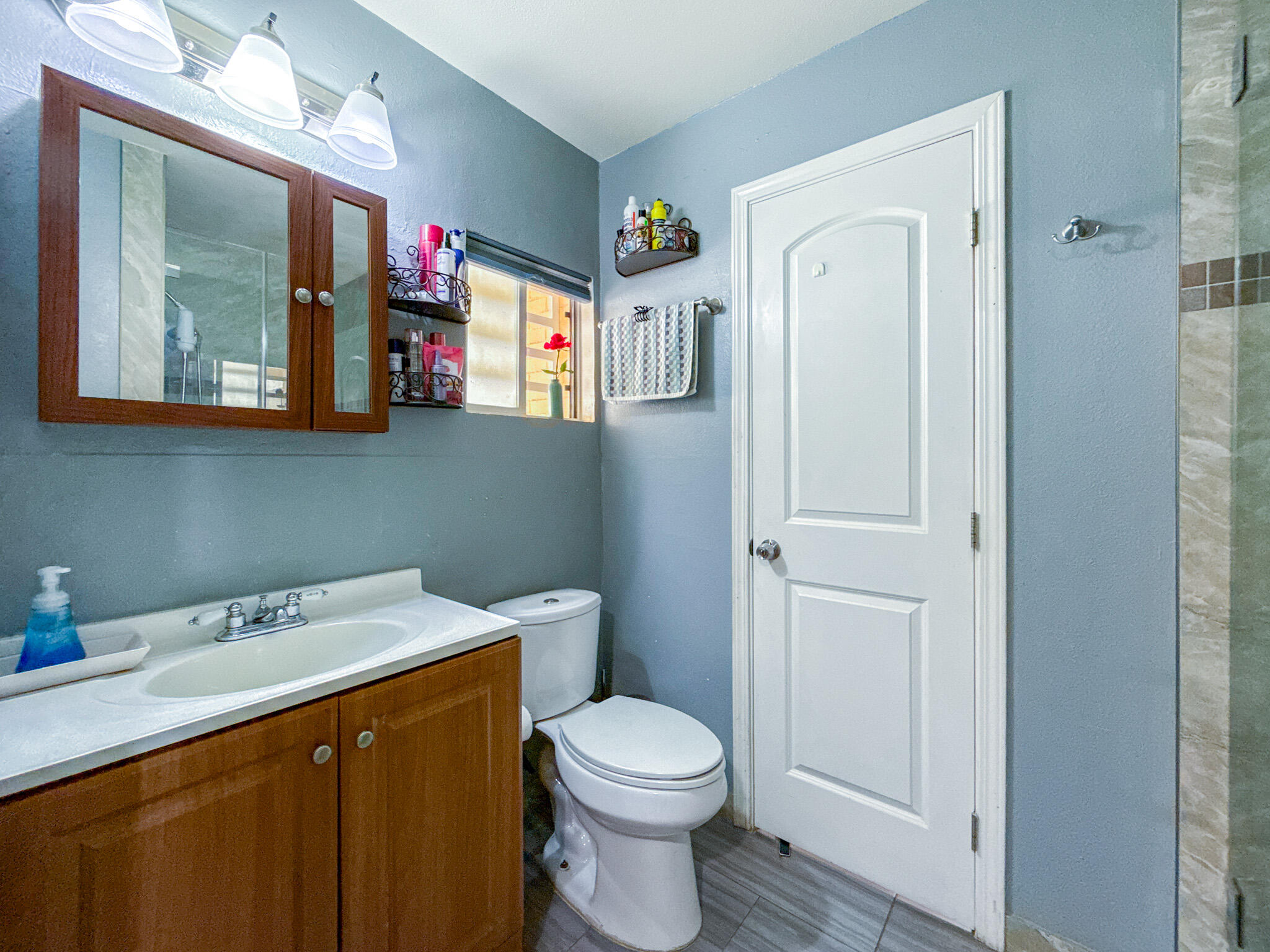 45431 Sancroft Avenue Lancaster, CA 93535 - Photo 32 of 49 a bathroom with a toilet a sink and a mirror