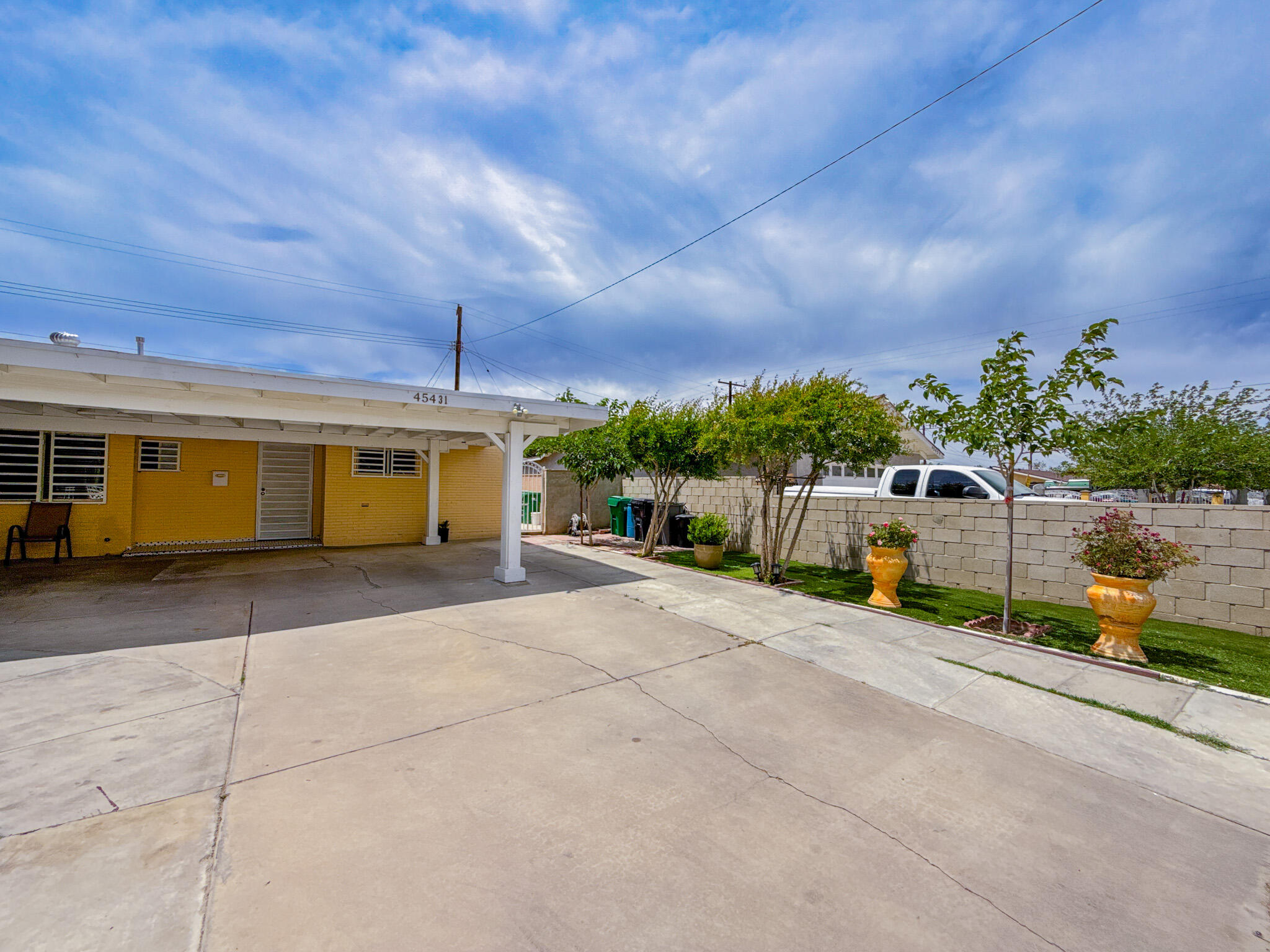 45431 Sancroft Avenue Lancaster, CA 93535 - Photo 5 of 49 a view of a house with a yard and garage