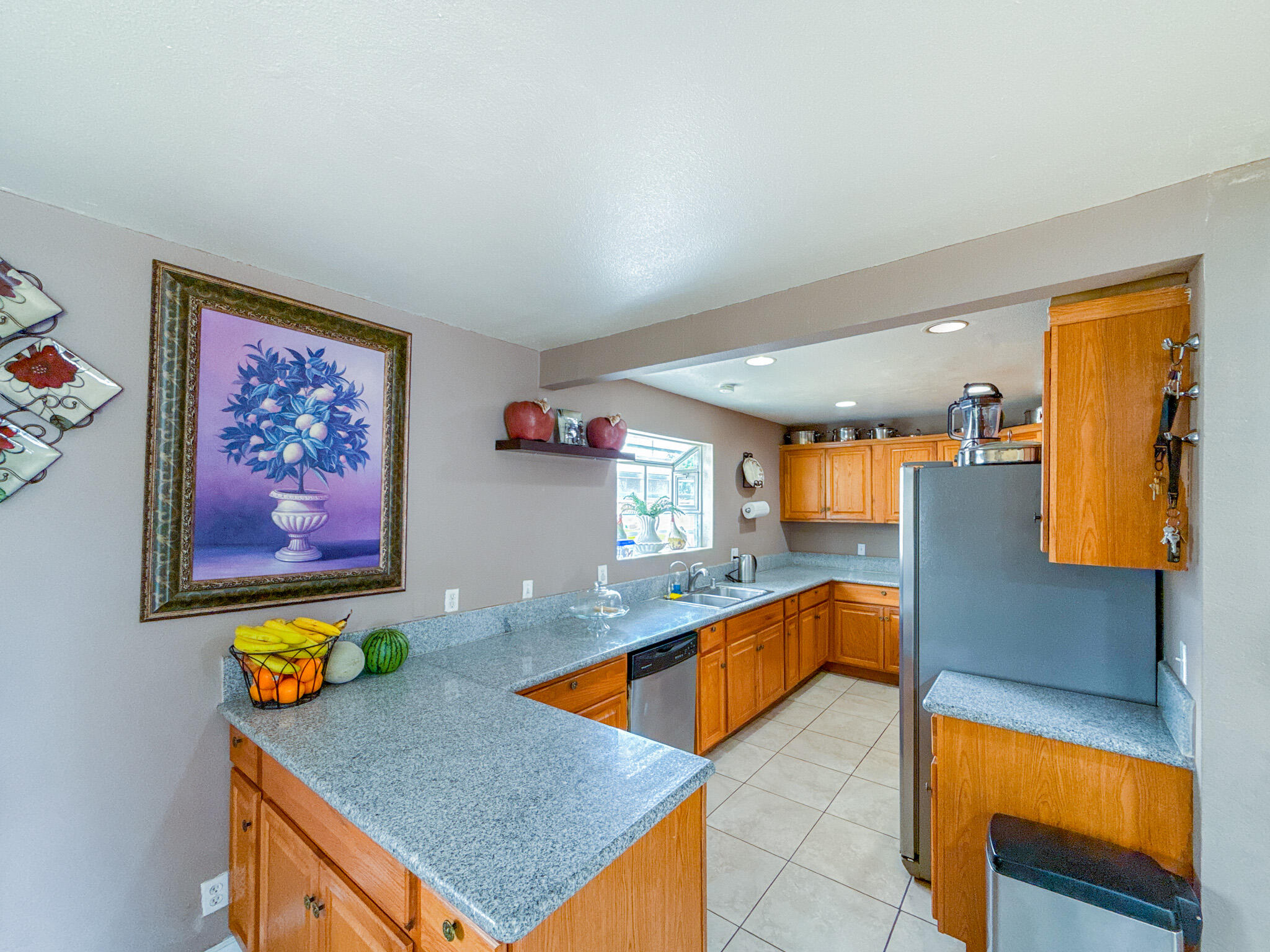 45431 Sancroft Avenue Lancaster, CA 93535 - Photo 10 of 49 a kitchen with stainless steel appliances granite countertop a stove a sink and a microwave