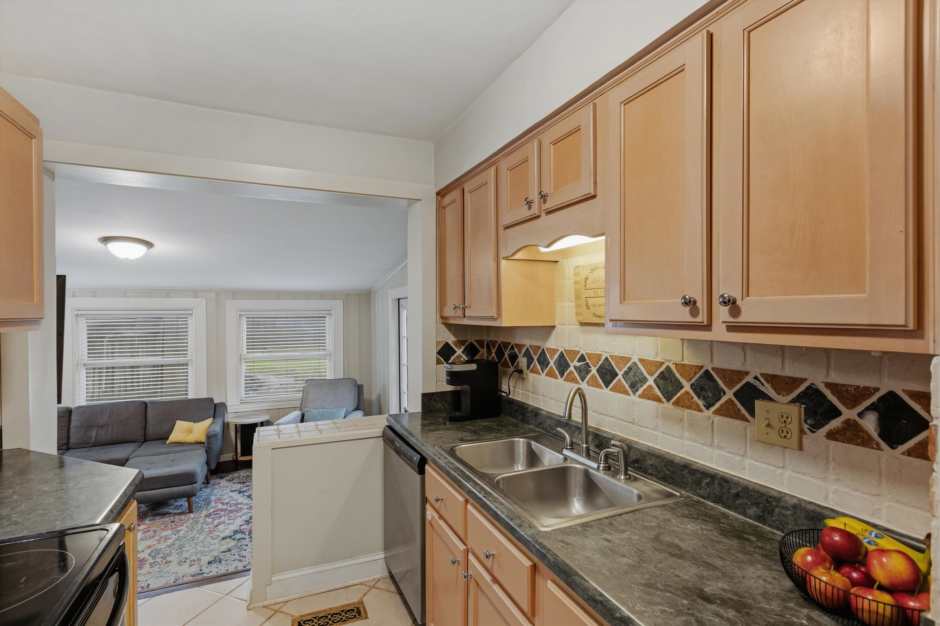100 South Greer Street Memphis, TN 38111 - Photo 12 of 26 a kitchen with granite countertop a sink and a refrigerator