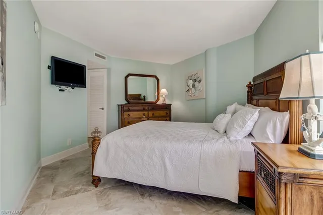 a bedroom with a bed and a television