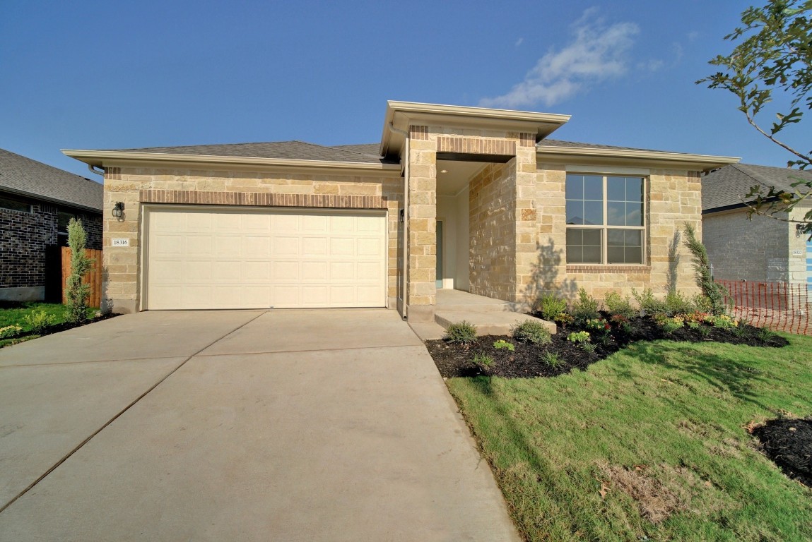 18316 Anicio Gallo Drive Pflugerville, TX 78660 - Photo 1 of 1 a front view of a house with a yard and garage