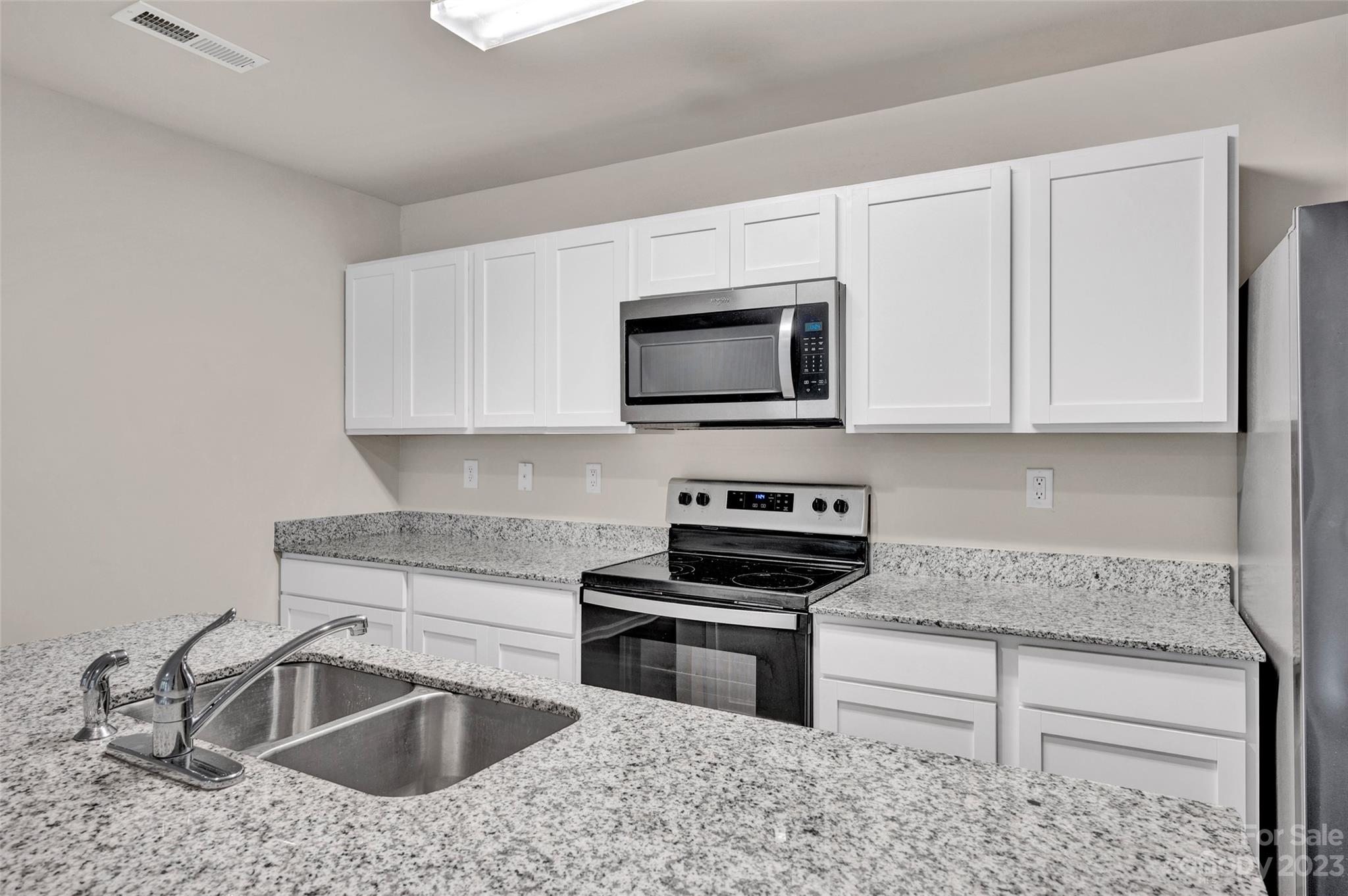 1476 Mulberry Ridge Drive Newton, NC 28658 - Photo 11 of 34 a kitchen with granite countertop a sink stove and microwave