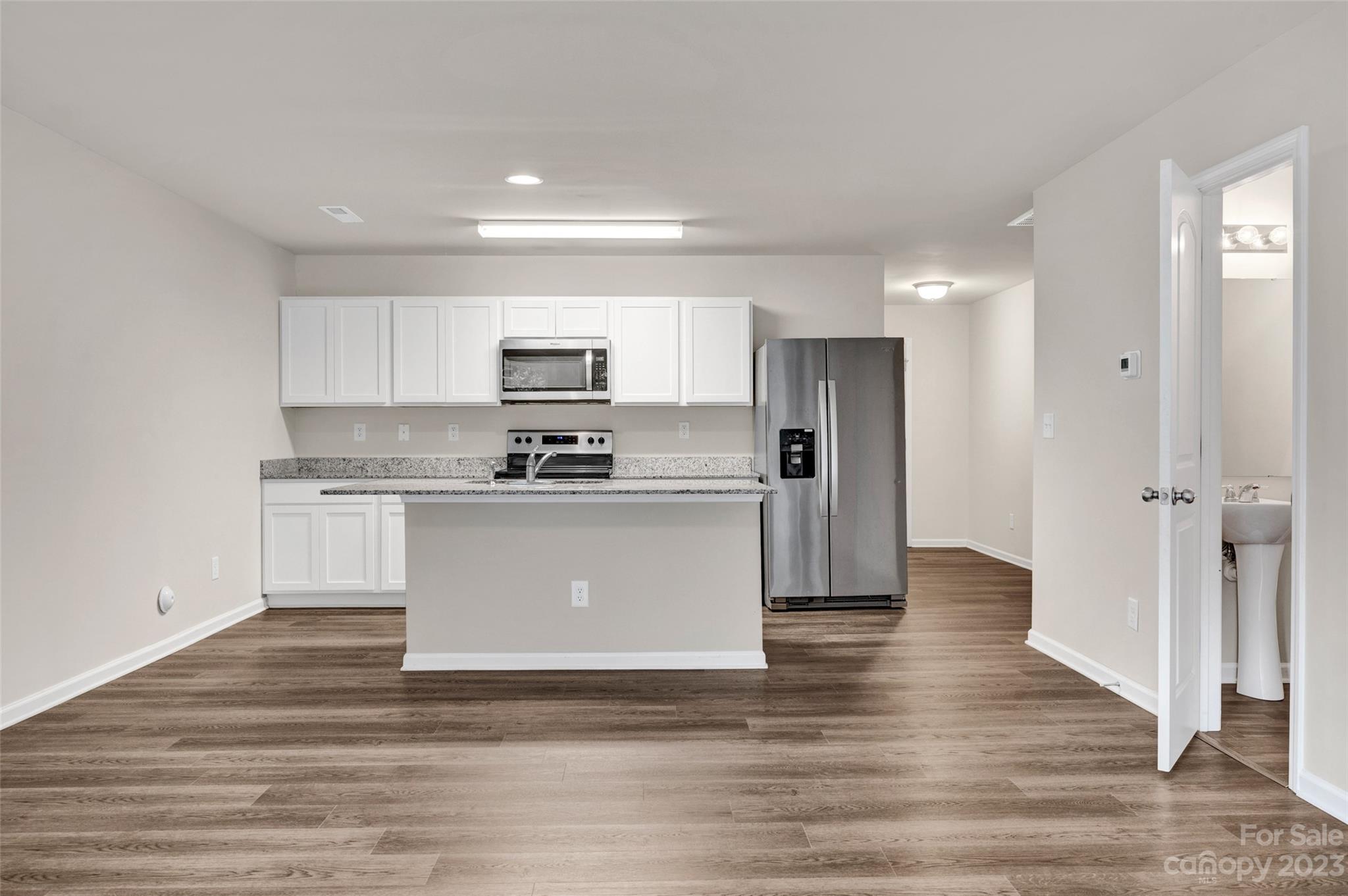 1476 Mulberry Ridge Drive Newton, NC 28658 - Photo 12 of 34 a kitchen with a refrigerator stove top oven and cabinets