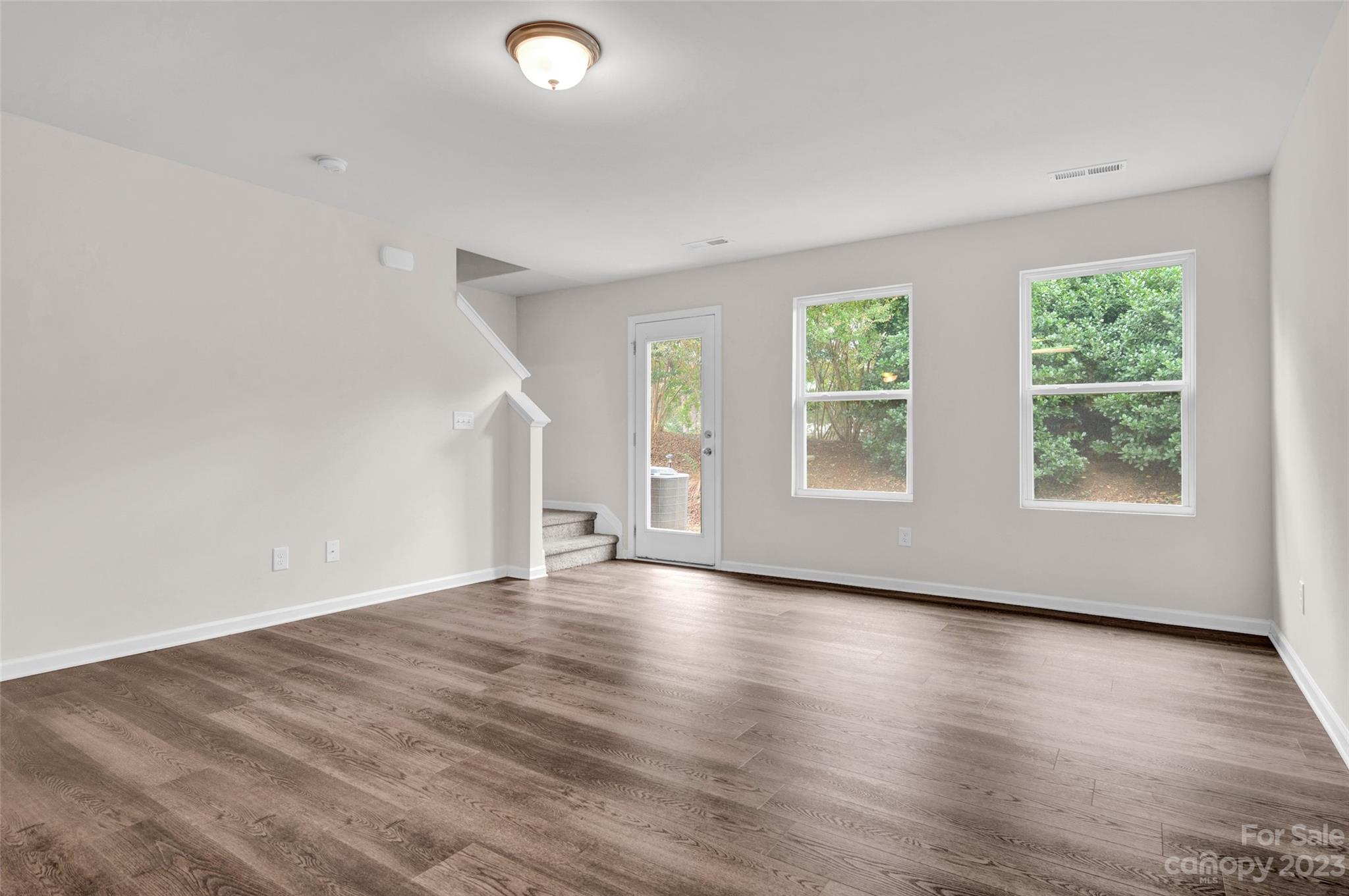 1476 Mulberry Ridge Drive Newton, NC 28658 - Photo 15 of 34 an empty room with wooden floor and windows