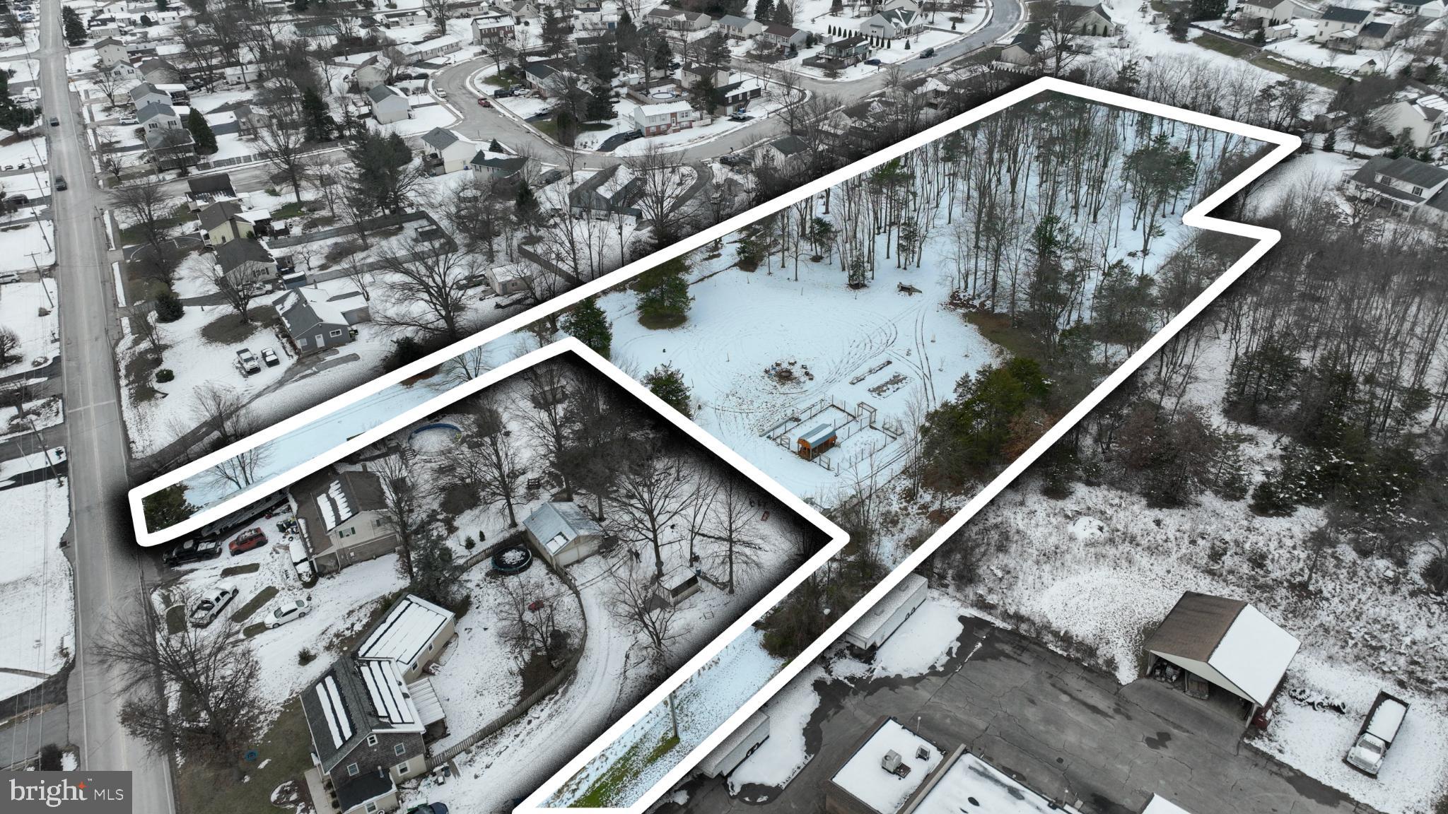 Expansive snowy lot in a serene neighborhood.