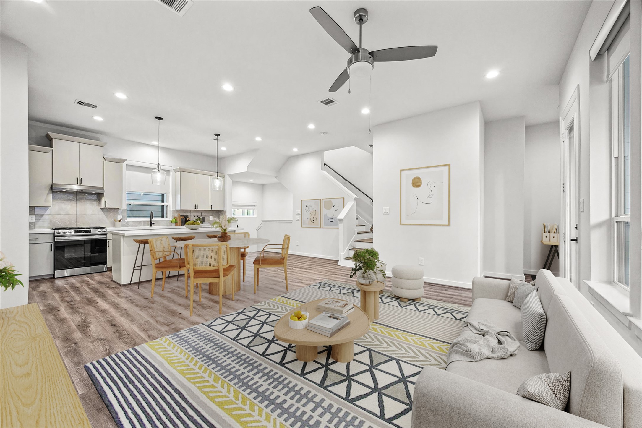 a living room with lots of furniture and kitchen view