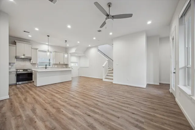 a view of a small space with wooden floor and a window