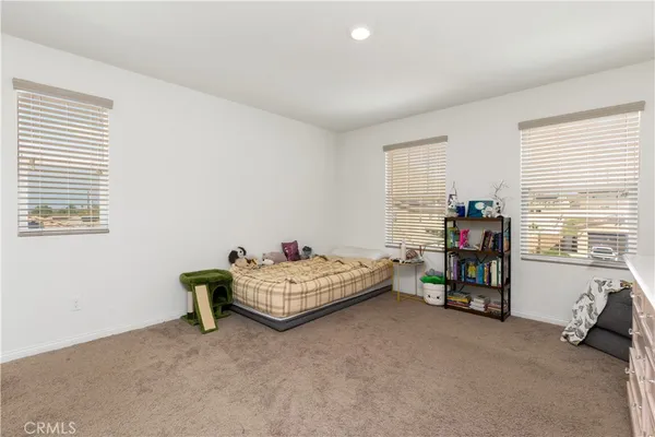 a bedroom with bed and a window