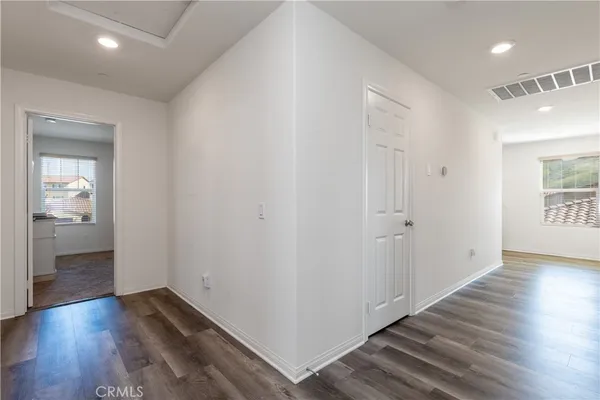 a view of a hallway with wooden floor