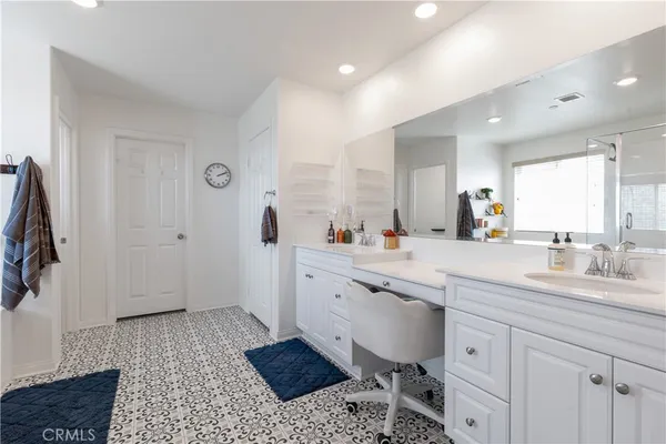 a spacious bathroom with a sink a mirror and a shower