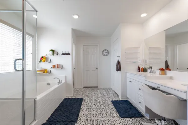 a bathroom with a sink a large mirror and a bathtub