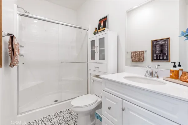 a bathroom with a sink a toilet and shower