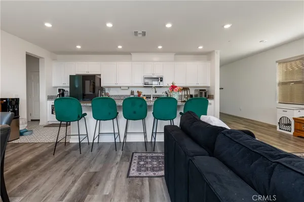 a living room with furniture potted plant and a wooden floor