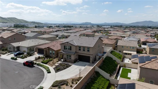 an aerial view of a house with a garden and mountain view