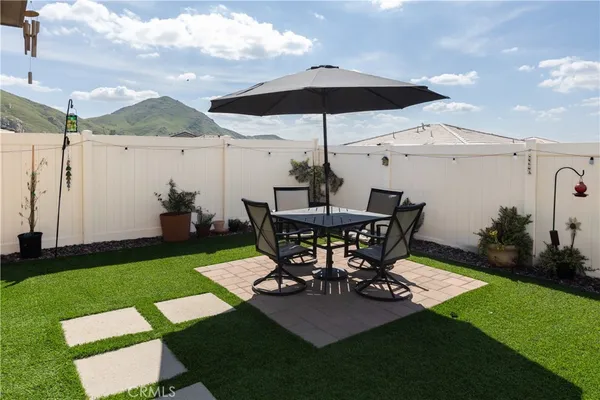 a view of a backyard with sitting area and furniture