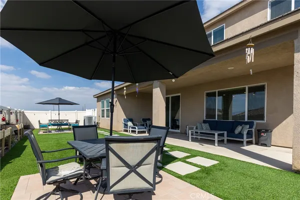 a view of a backyard with sitting area
