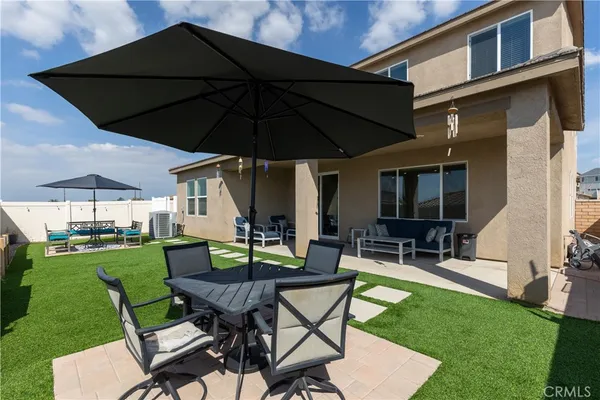 a view of a backyard with furniture porch and a garden