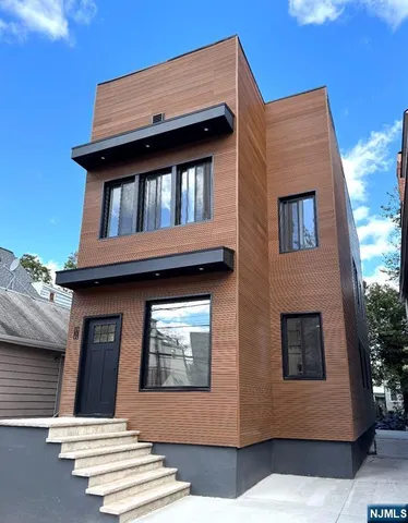a view of brick house with large windows