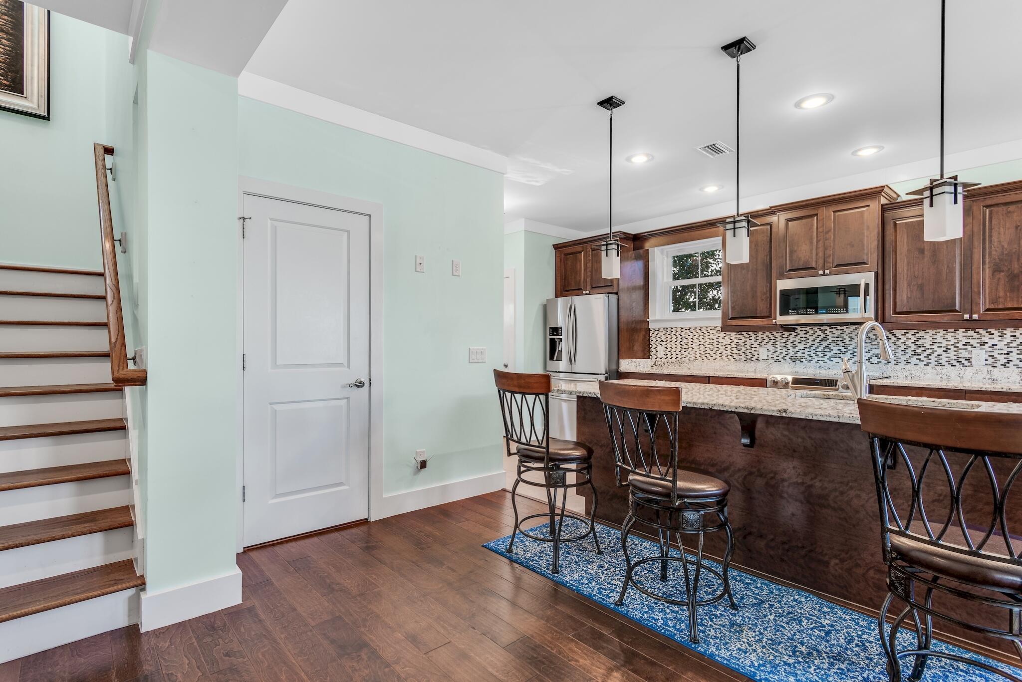 225 Turtle Cove Panama City Beach, FL 32413 - Photo 11 of 43 a large kitchen with a table and chairs