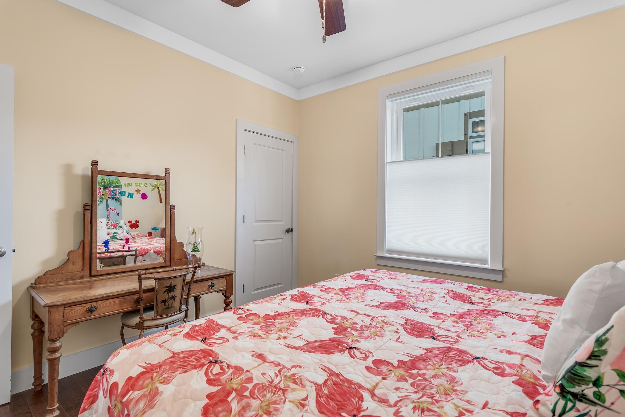 225 Turtle Cove Panama City Beach, FL 32413 - Photo 15 of 43 a bedroom with a bed and a dresser in it