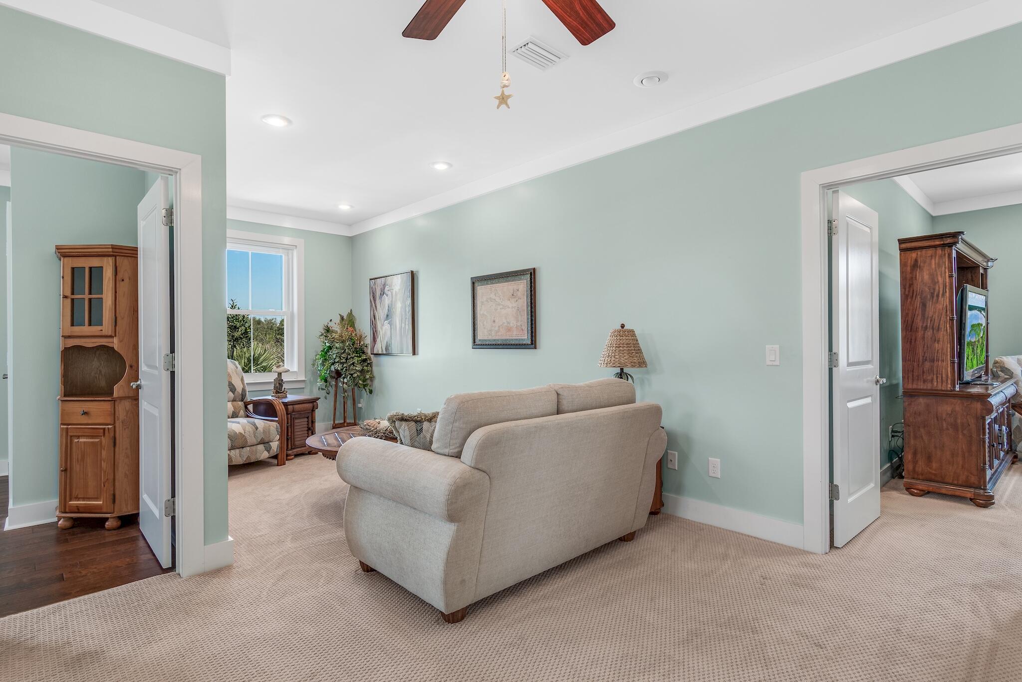 225 Turtle Cove Panama City Beach, FL 32413 - Photo 16 of 43 a living room with furniture and a flat screen tv