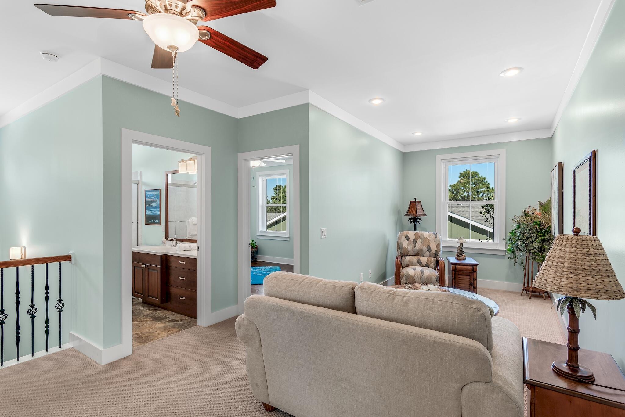 225 Turtle Cove Panama City Beach, FL 32413 - Photo 17 of 43 a living room with furniture and a chandelier