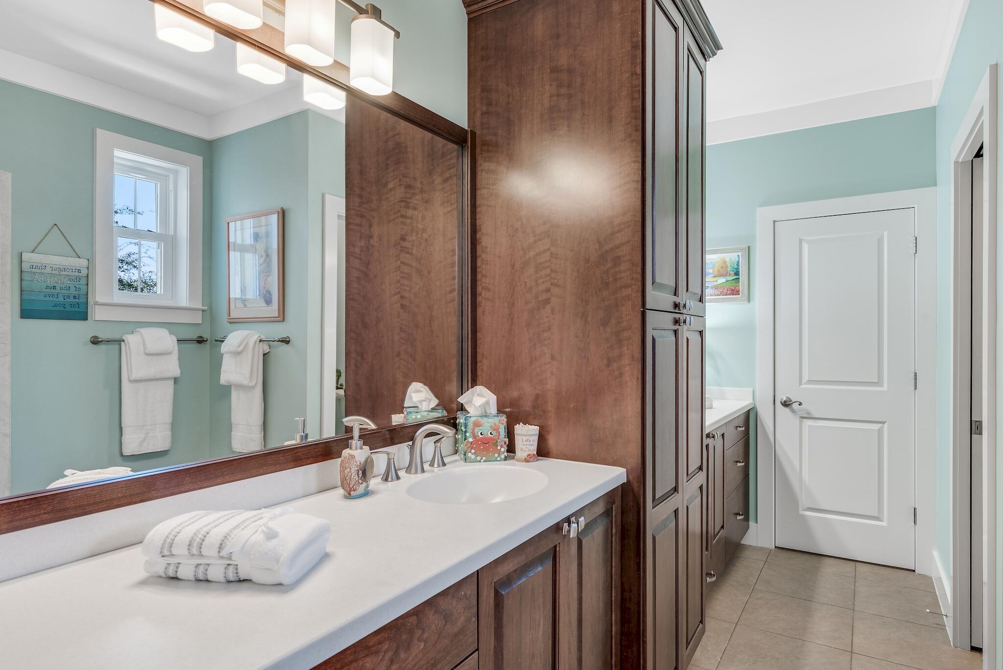 225 Turtle Cove Panama City Beach, FL 32413 - Photo 20 of 43 a bedroom with a bed and a mirror