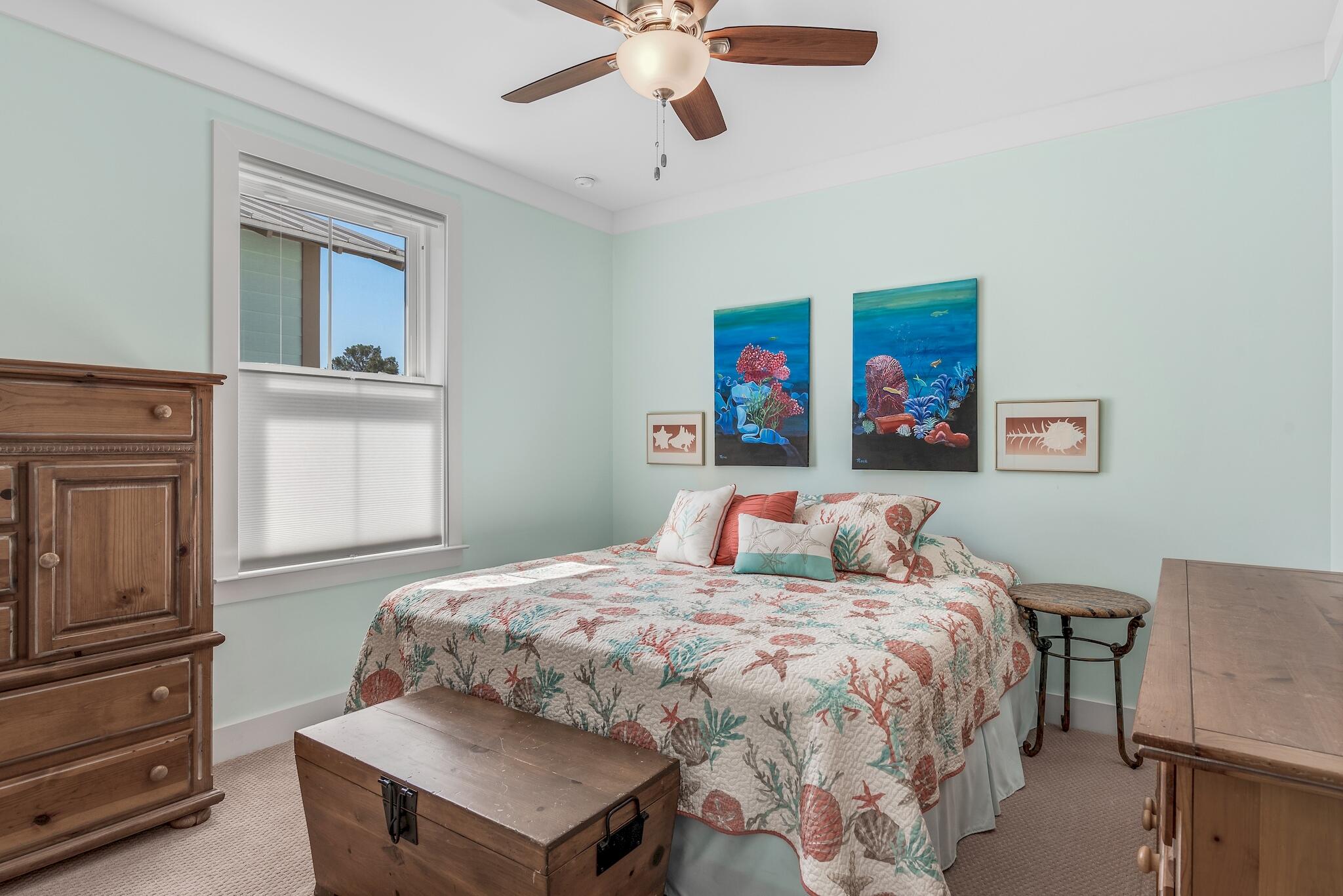 225 Turtle Cove Panama City Beach, FL 32413 - Photo 23 of 43 a bedroom with a bed and a chandelier